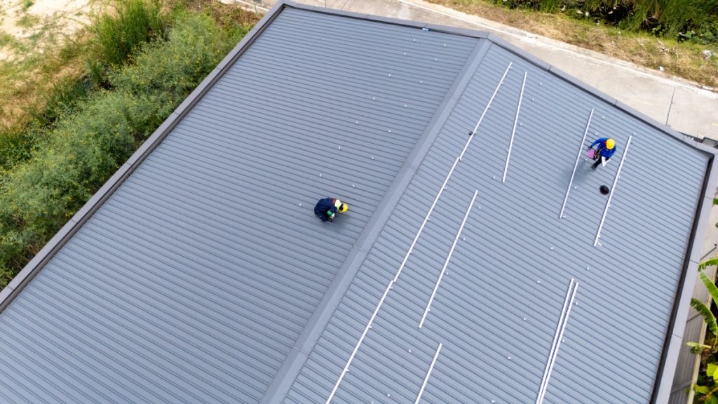 Commercial roofing contractor inspecting a flat roof in Jacksonville, Florida